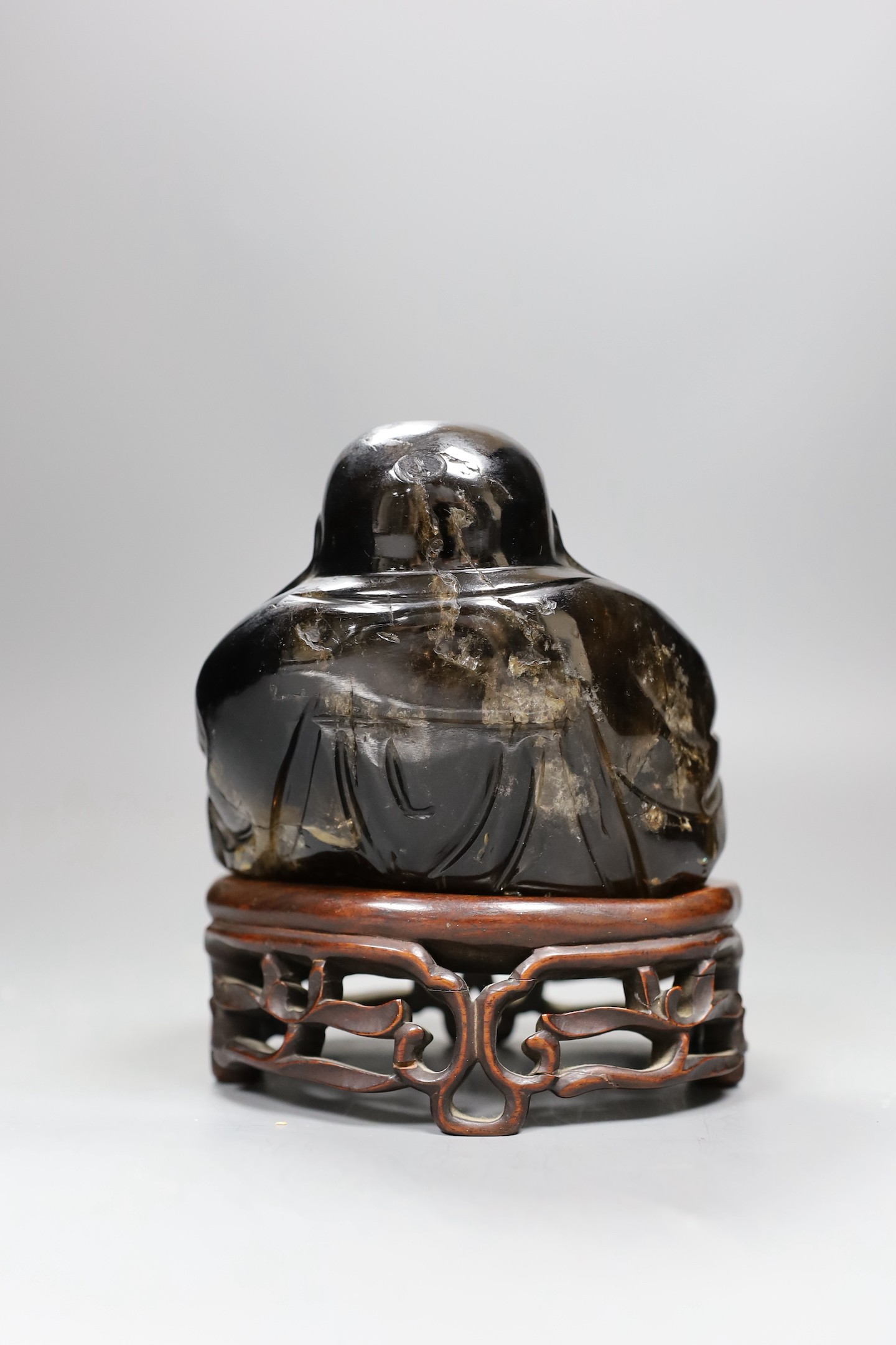 A large Chinese smoky quartz figure of Budai, 17cm tall including wood stand